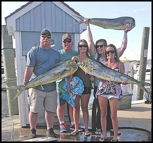 happy Hatteras fishing charter has fun displaying their catch on the dock
