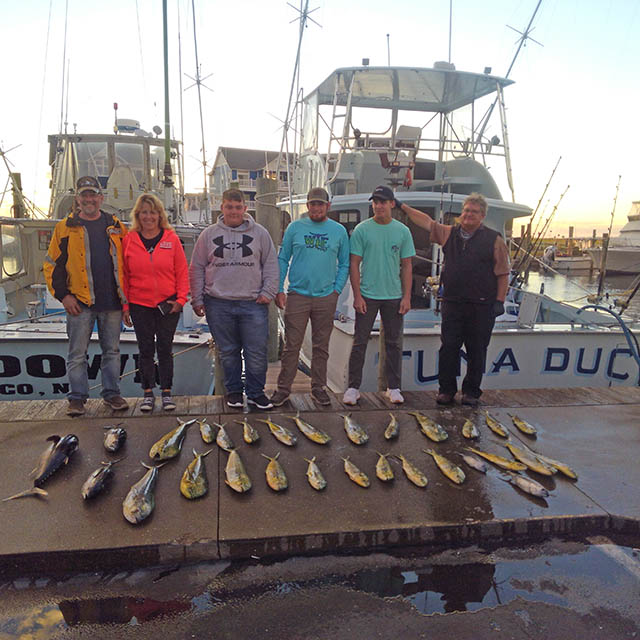 Anglers pose on the dock with their catch of tuna and mahi.