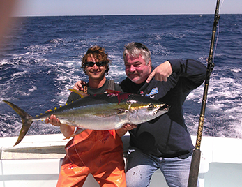 men holding yellowfin tuna